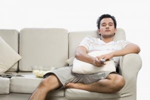 a-man-sitting-on-a-sofa-watching-tv-300x200 عادات يومية تؤثر على الصحة سلباً عليك تجنبها